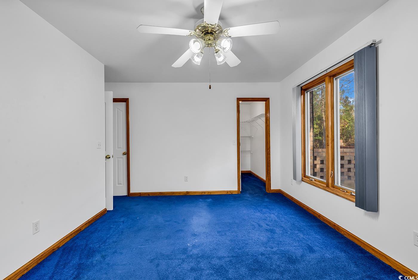 5938 Rahnavard Boulevard Myrtle Beach, SC 29588 - Photo 23 of 39 Empty room with ceiling fan and dark carpet