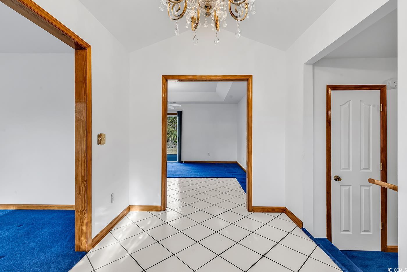 5938 Rahnavard Boulevard Myrtle Beach, SC 29588 - Photo 3 of 39 Hallway featuring a notable chandelier, lofted cei