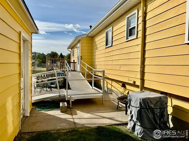 a view of balcony with wooden floor and iron fence