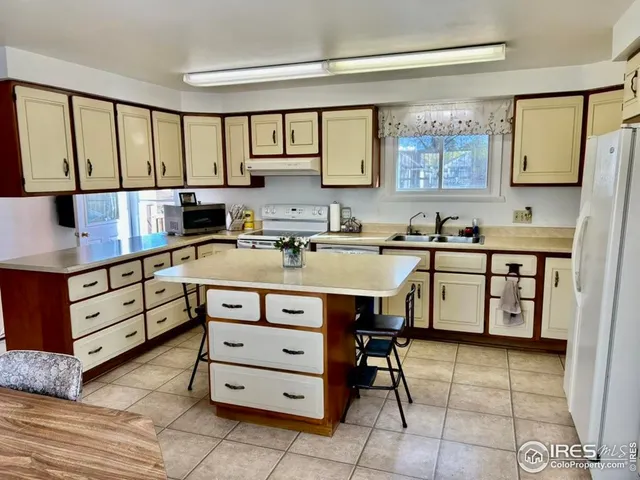 a kitchen with a stove a sink and a refrigerator