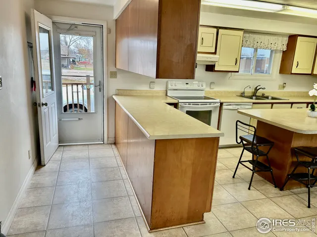 a kitchen that has a cabinets a sink and a stove in it