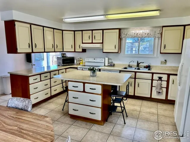 a kitchen with a stove a sink and a refrigerator