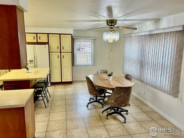 a view of a dining room with furniture and a chandelier