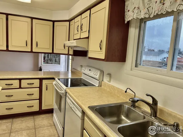 a kitchen that has a sink and a stove