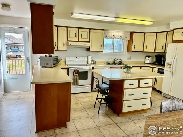 a kitchen with a stove a sink and a refrigerator