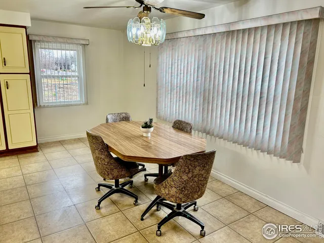 a view of a dining room with furniture and chandelier