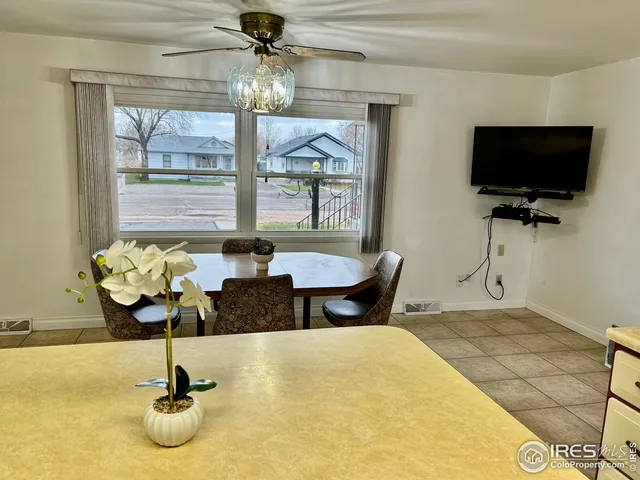 a dining room with furniture and window