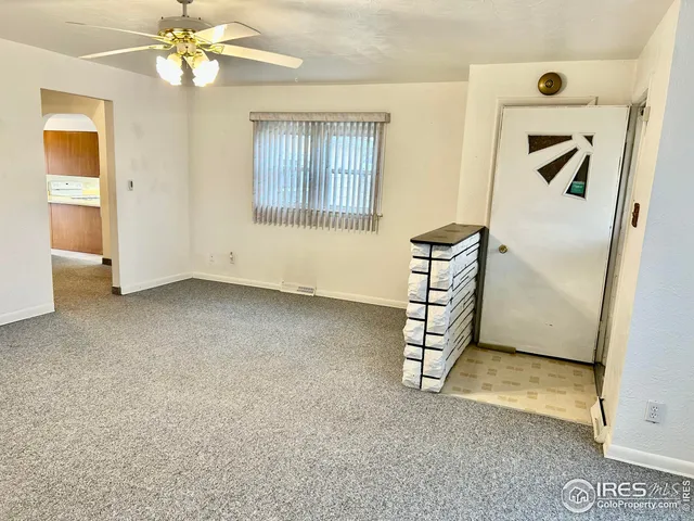 an empty room with windows and closet