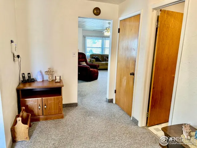 a view of a hallway with closet and a mirror