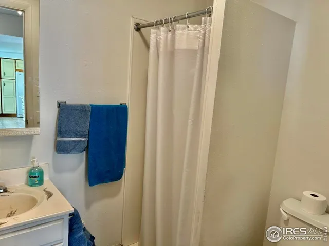 a bathroom with a shower curtain and a sink