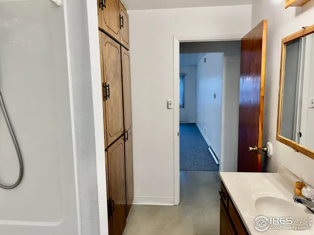 a bathroom with a tub sink and mirror