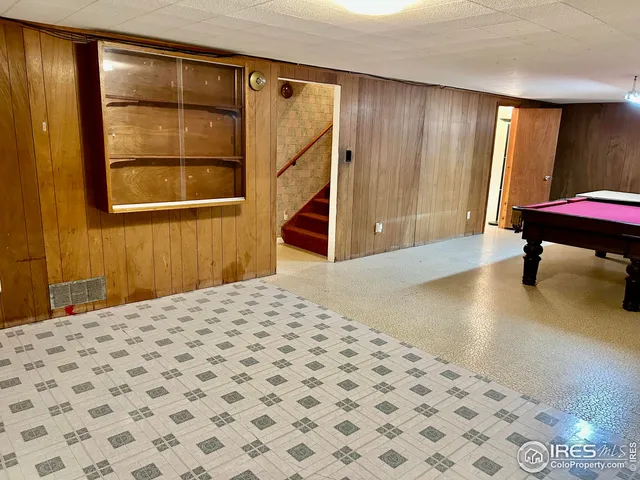 a bedroom with a bed and a dresser with mirror