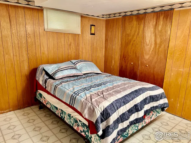 a bedroom with a bed and curtain