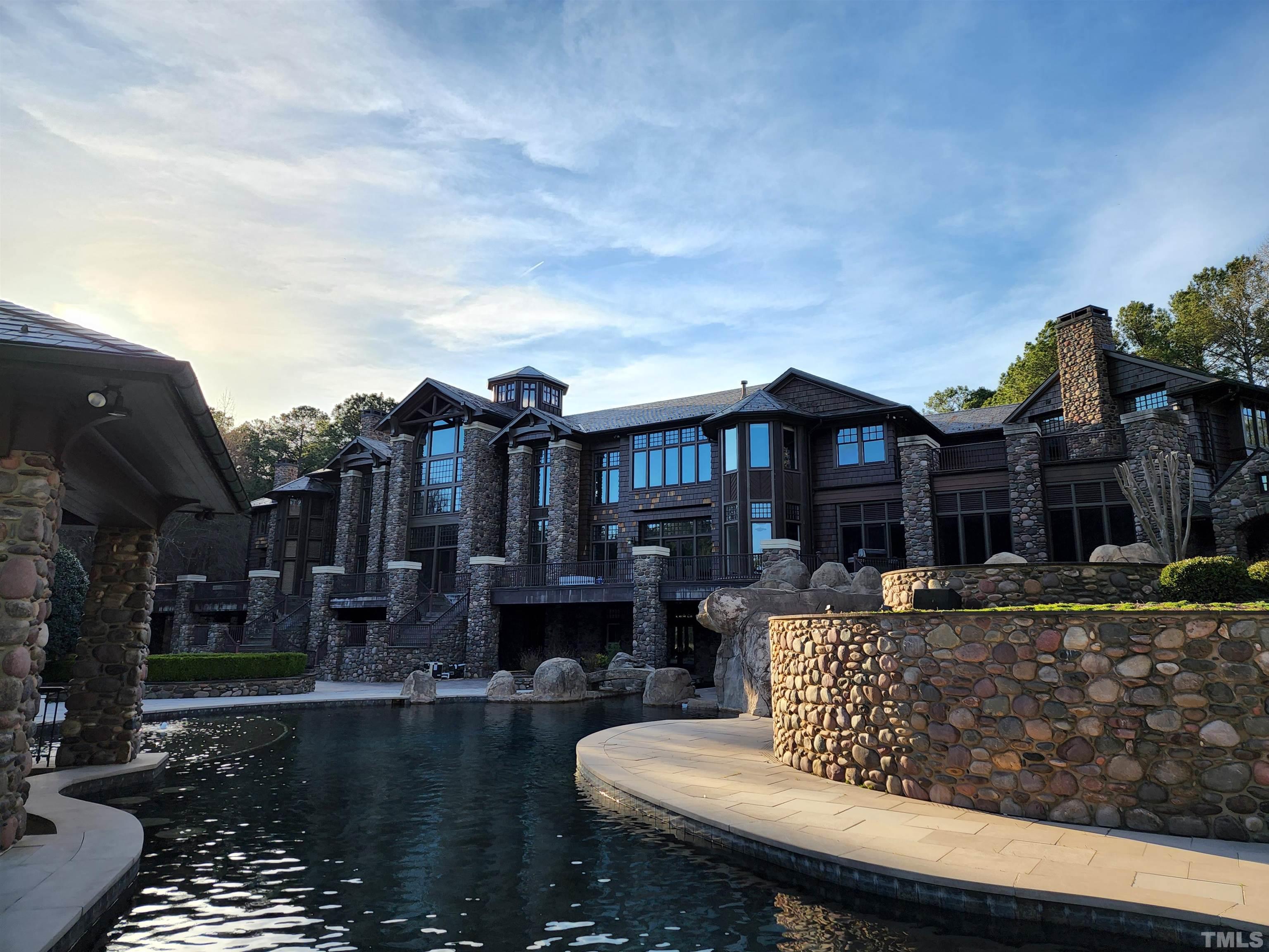 a front view of a house with swimming pool having outdoor seating