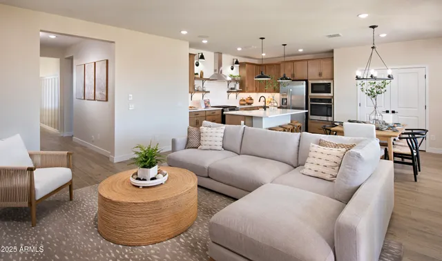 a living room with furniture kitchen and a large window