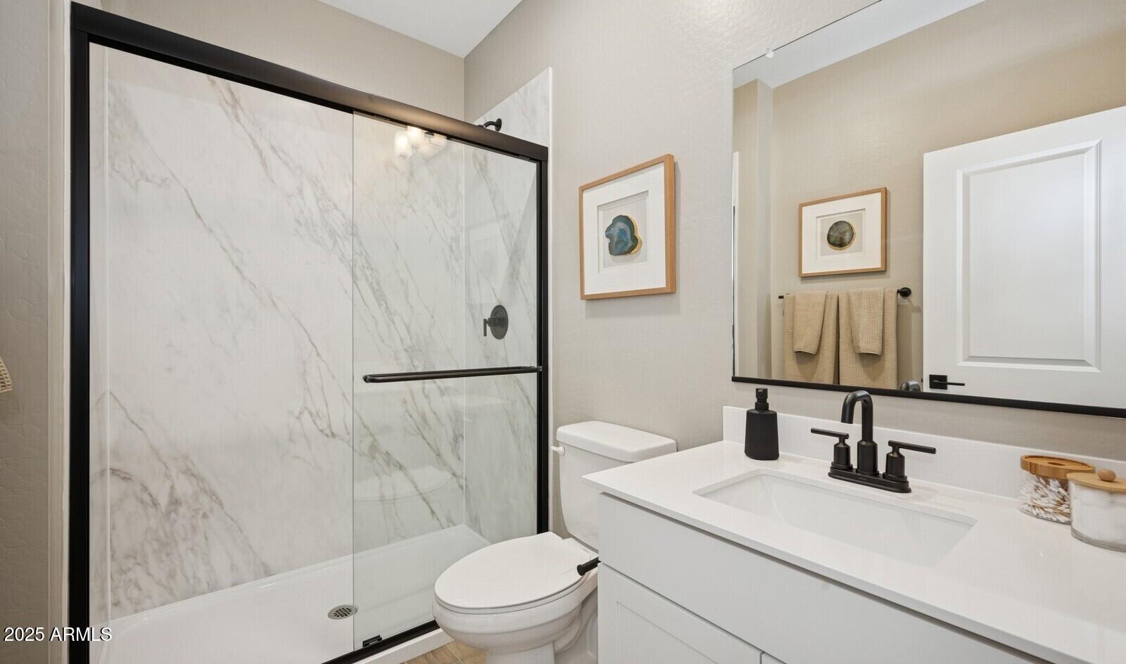8014 West Royal Palm Road Peoria, AZ 85345 - Photo 16 of 37 a bathroom with a sink a toilet and shower