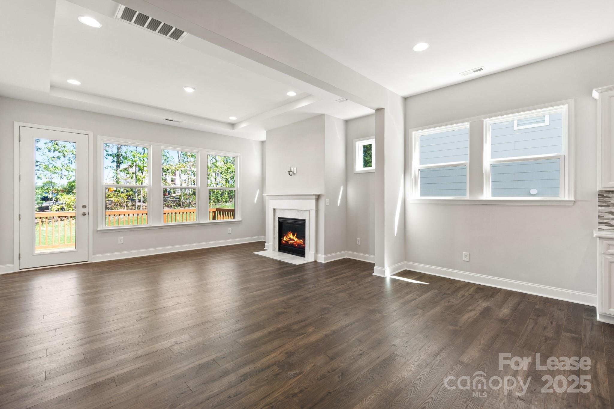 17118 Sand Bank Road Charlotte, NC 28278 - Photo 12 of 37 an empty room with wooden floor and windows