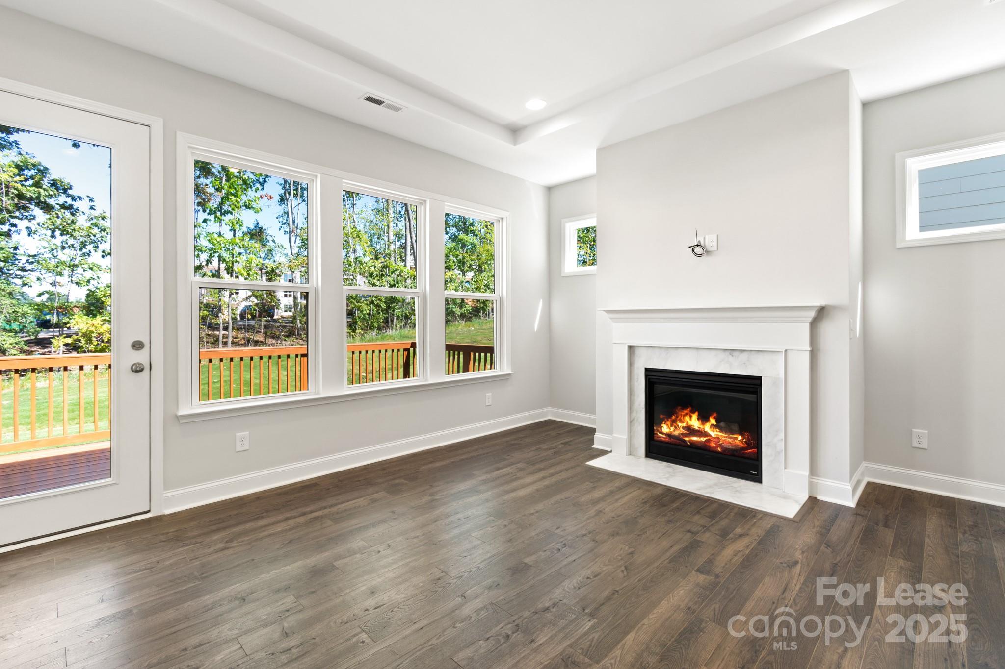 17118 Sand Bank Road Charlotte, NC 28278 - Photo 14 of 37 a view of an empty room with wooden floor and a window