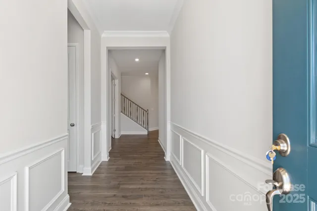 a view of a hallway with wooden floor and entryway
