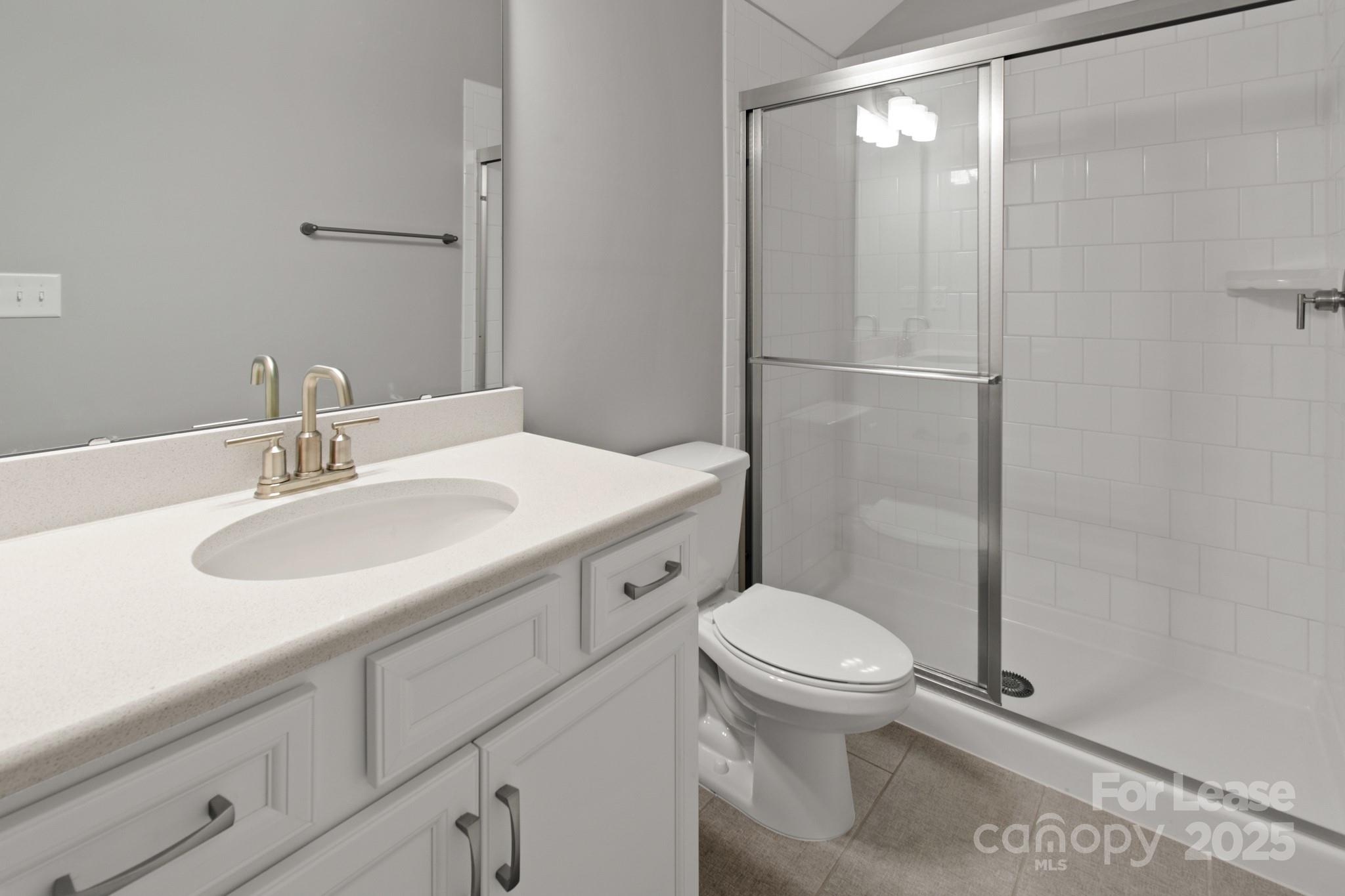 17118 Sand Bank Road Charlotte, NC 28278 - Photo 28 of 37 a bathroom with a sink toilet and shower