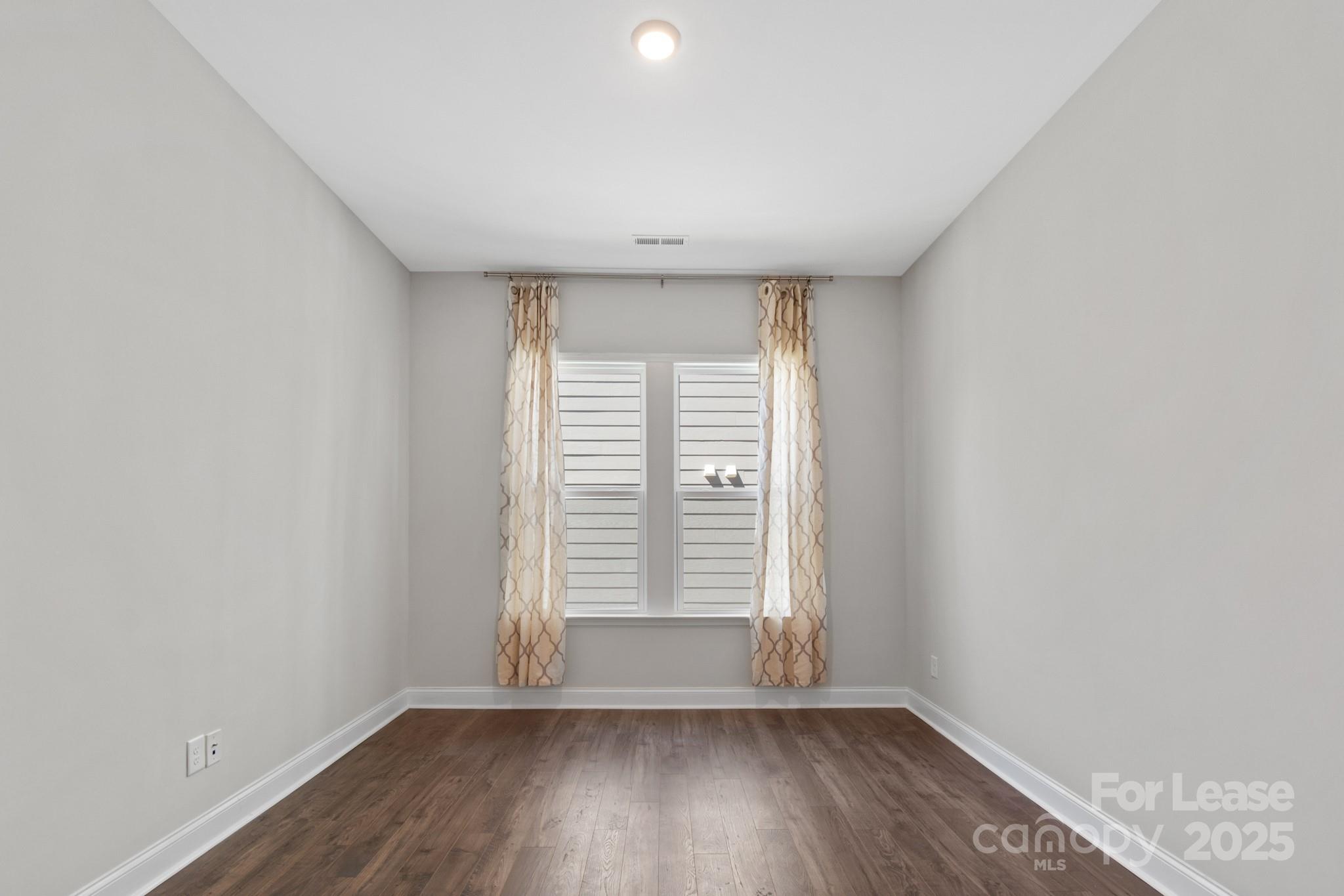 17118 Sand Bank Road Charlotte, NC 28278 - Photo 5 of 37 wooden floor in an empty room with a window