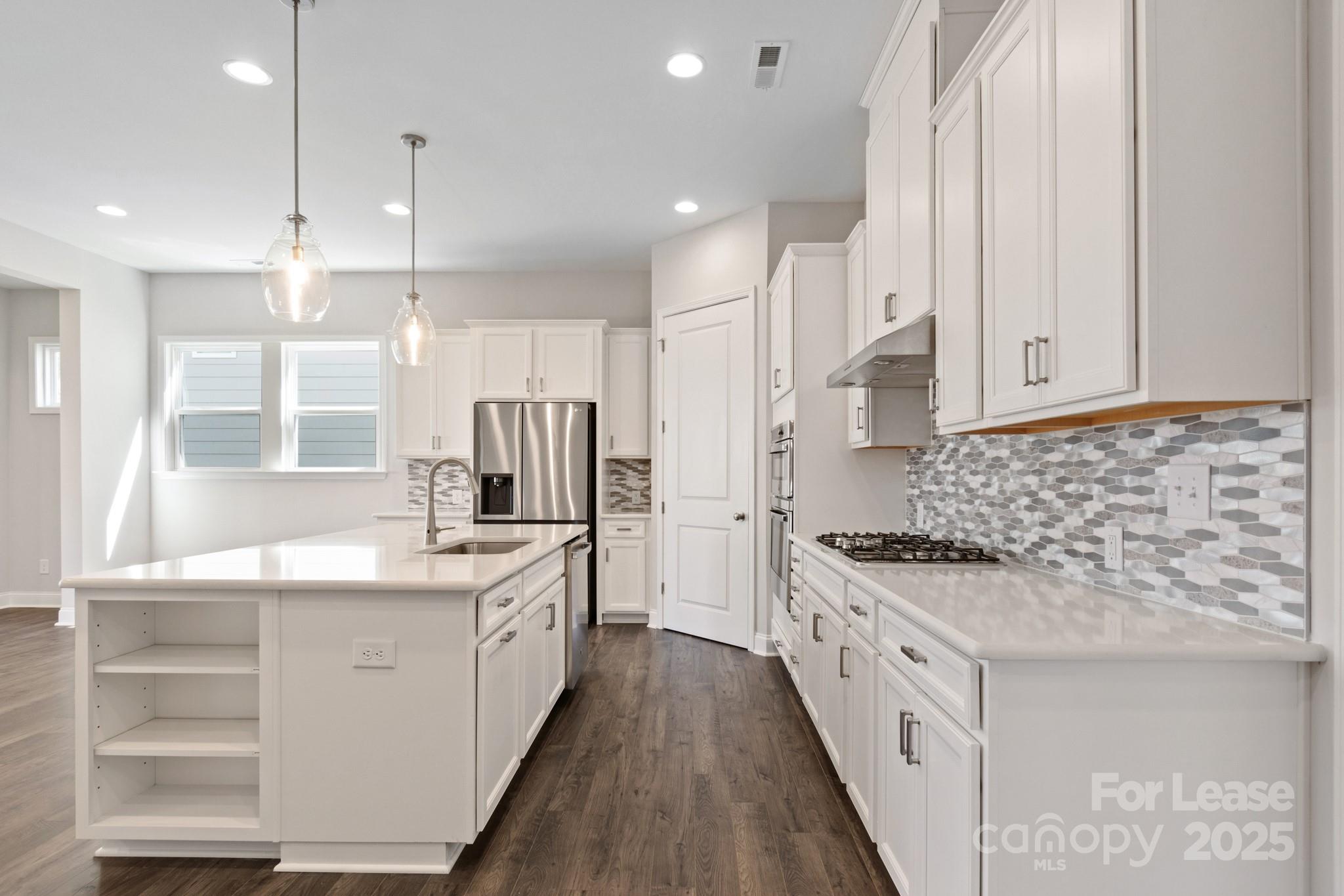 17118 Sand Bank Road Charlotte, NC 28278 - Photo 7 of 37 a kitchen with stainless steel appliances kitchen island granite countertop a stove and a sink