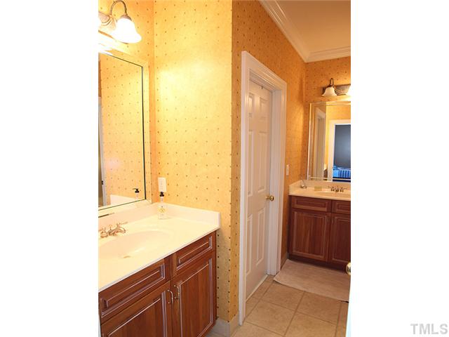 3303 Ruffin Street Raleigh, NC 27607 - Photo 21 of 25 a bathroom with a granite countertop sink and a mirror