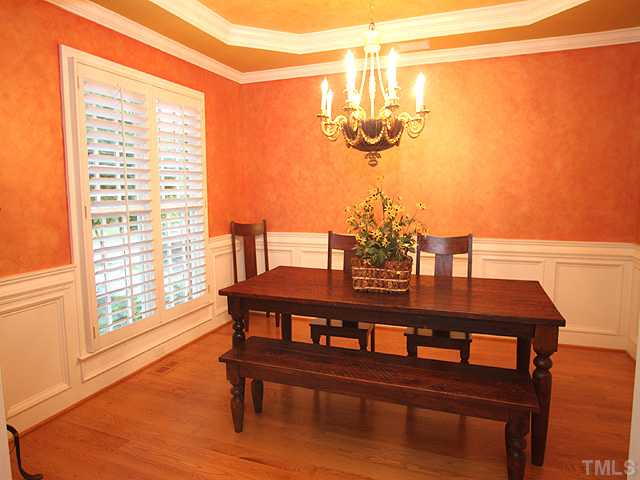 3303 Ruffin Street Raleigh, NC 27607 - Photo 4 of 25 a view of a dining room with furniture a chandelier and wooden floor