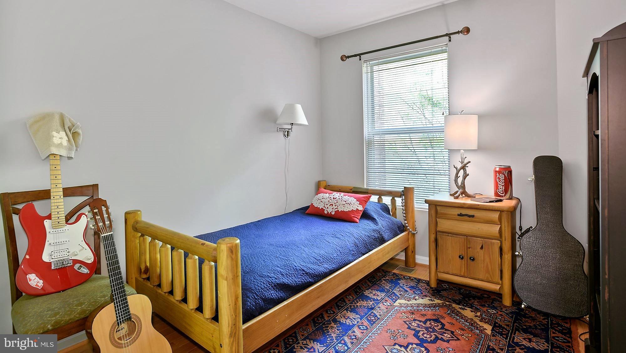 12062 Edgemere Circle Reston, VA 20190 - Photo 19 of 25 a bedroom with a bed and wooden floor