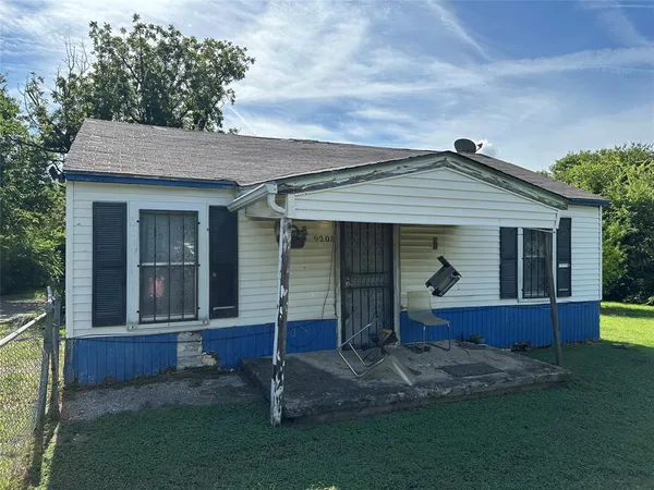a front view of a house with a garden and yard