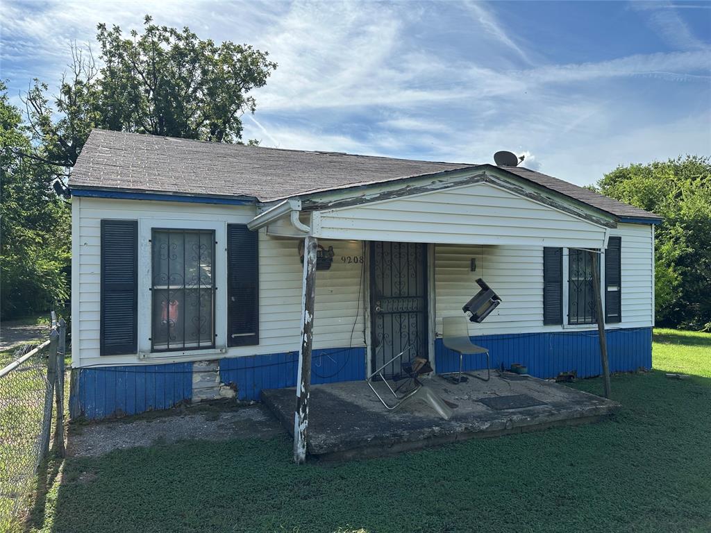 9208 Newhall Street Dallas, TX 75232 - Photo 2 of 8 a front view of a house with a garden and yard