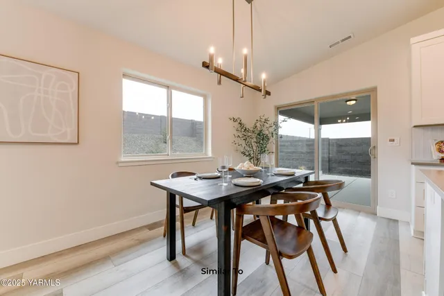 a dining room with furniture a chandelier and wooden floor