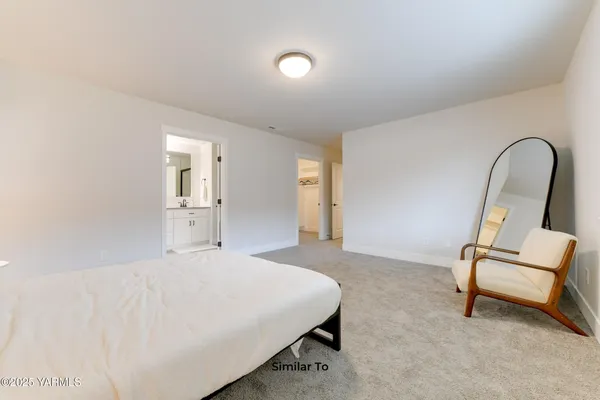 a bedroom with a bed and a couch