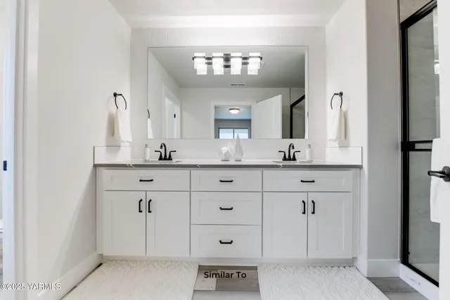 a bathroom with a sink vanity and a mirror