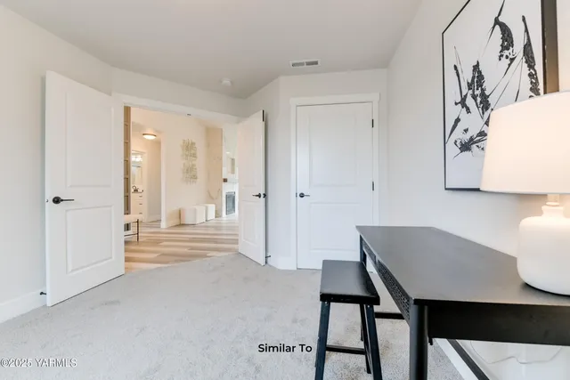 a view of a hallway with seating area