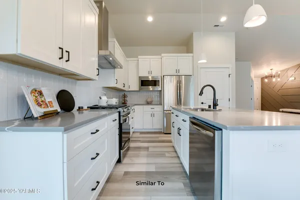 a kitchen with cabinets a sink and appliances