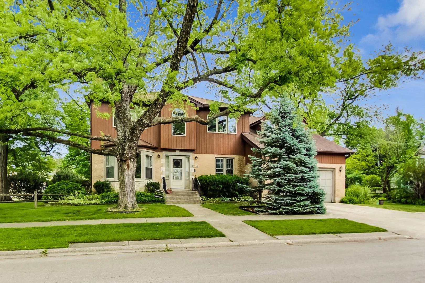 701 South Seminary Avenue Park Ridge, IL 60068 - Photo 1 of 60 a front view of a house with a yard and a garage