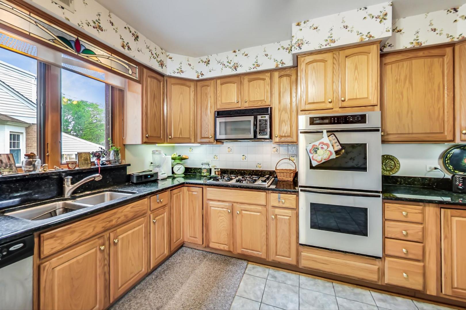 701 South Seminary Avenue Park Ridge, IL 60068 - Photo 15 of 60 a kitchen with stainless steel appliances granite countertop a stove sink and cabinets