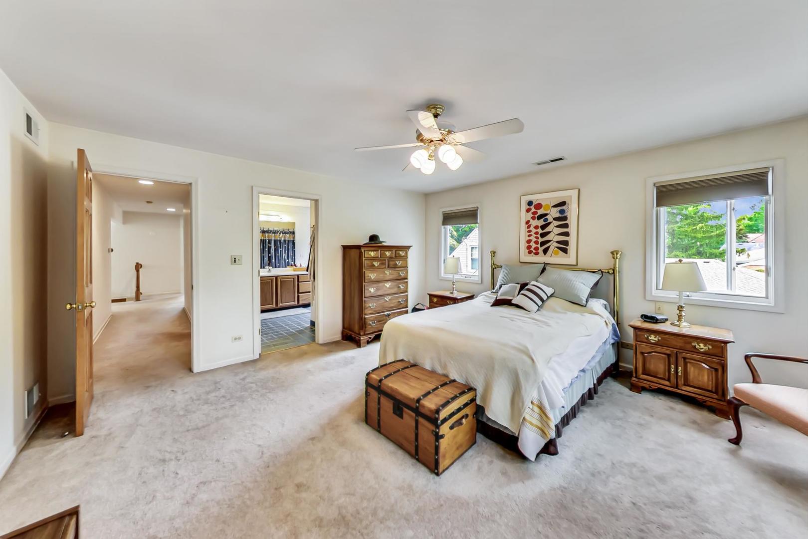 701 South Seminary Avenue Park Ridge, IL 60068 - Photo 28 of 60 a spacious bedroom with a balcony a bed and a chandelier