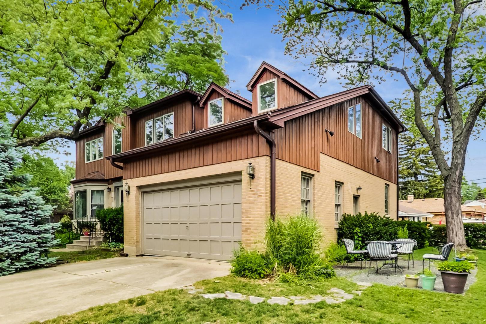 701 South Seminary Avenue Park Ridge, IL 60068 - Photo 4 of 60 a view of a house with a yard plants and large tree