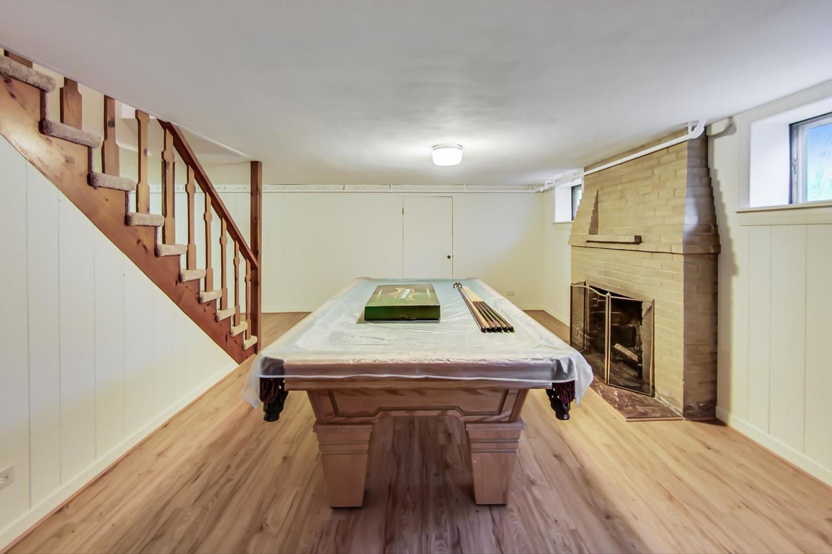 701 South Seminary Avenue Park Ridge, IL 60068 - Photo 41 of 60 a room with wooden floor pool table and chairs