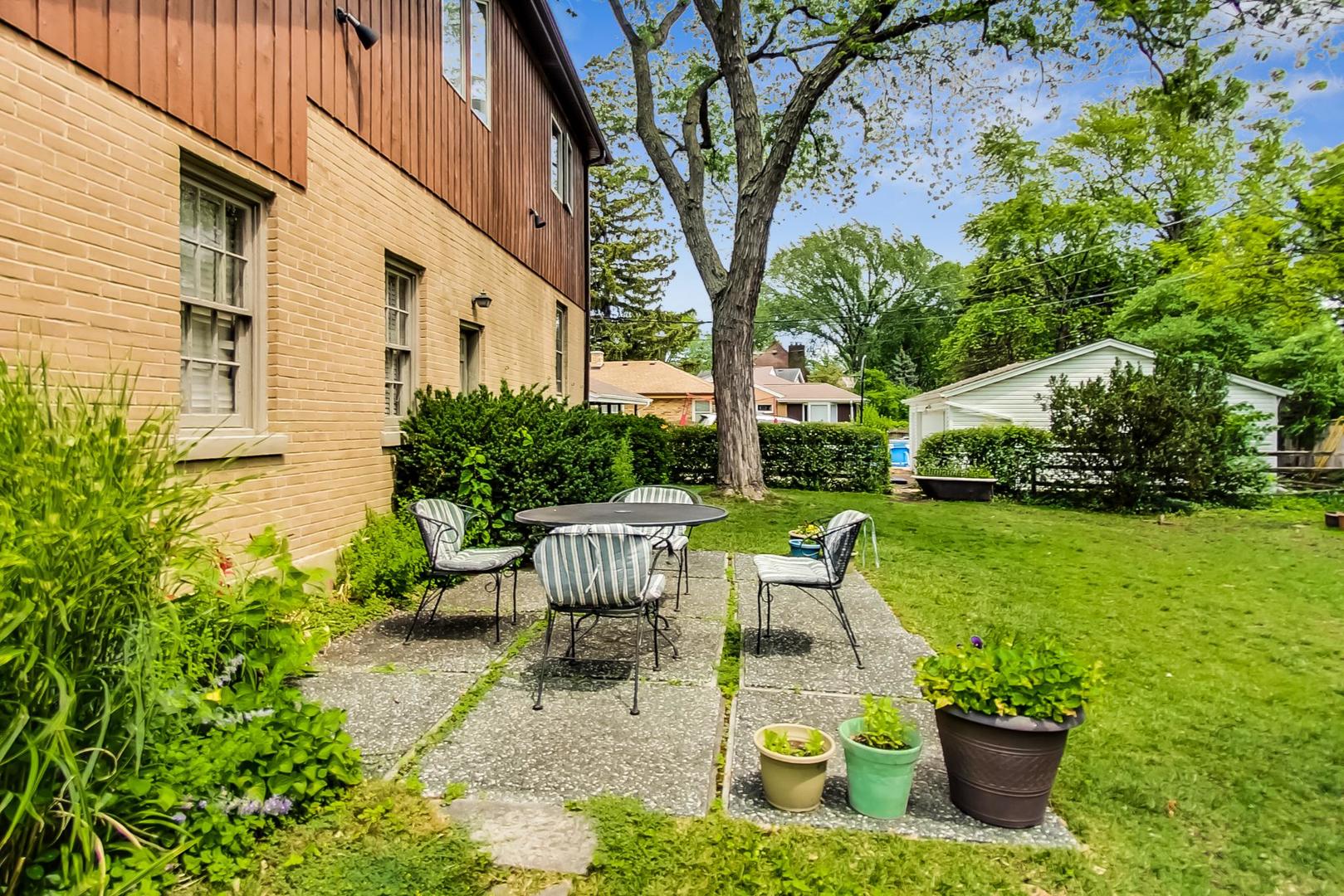 701 South Seminary Avenue Park Ridge, IL 60068 - Photo 53 of 60 a view of a patio with table and chairs potted plants and large tree