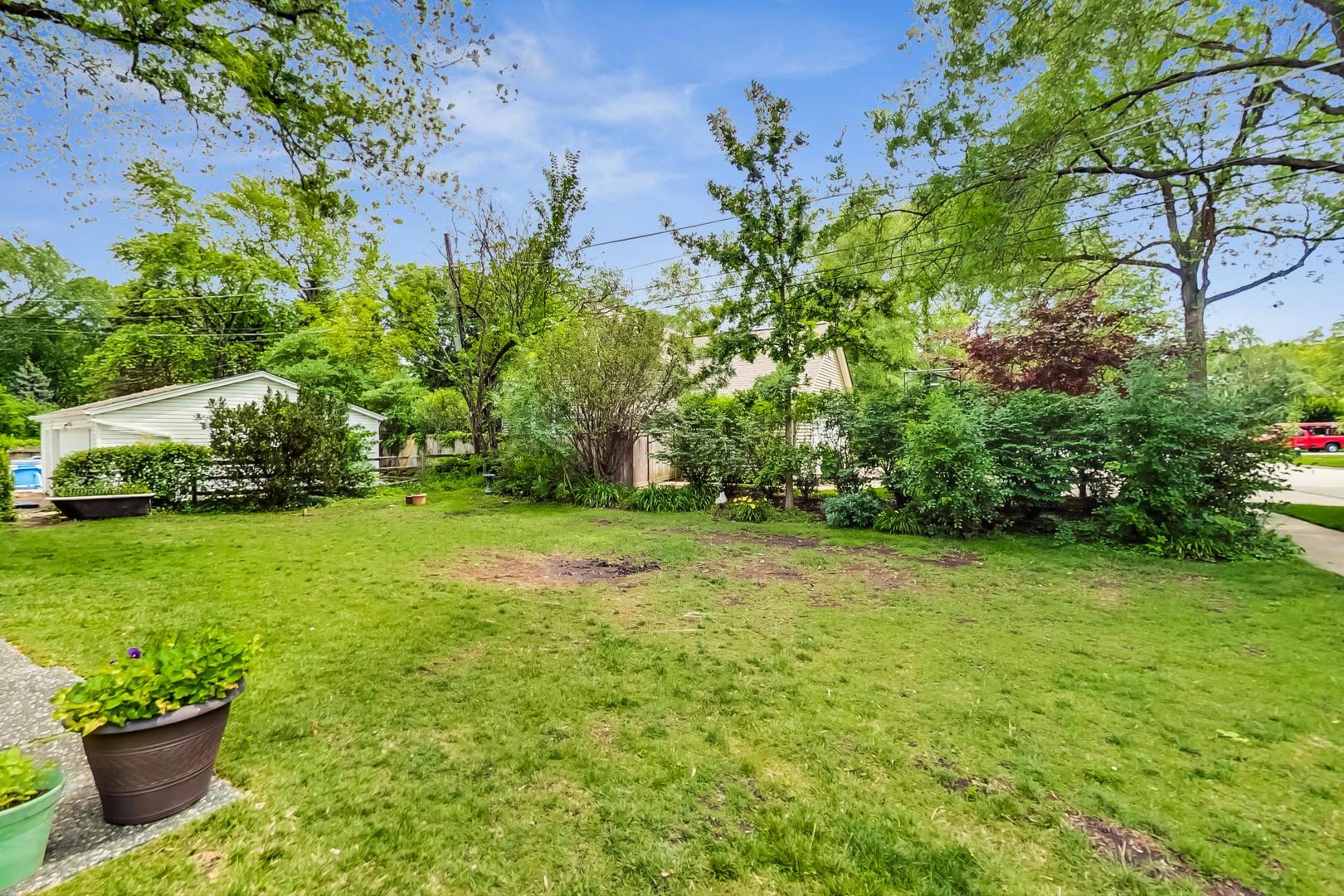 701 South Seminary Avenue Park Ridge, IL 60068 - Photo 55 of 60 a view of a garden with a bench