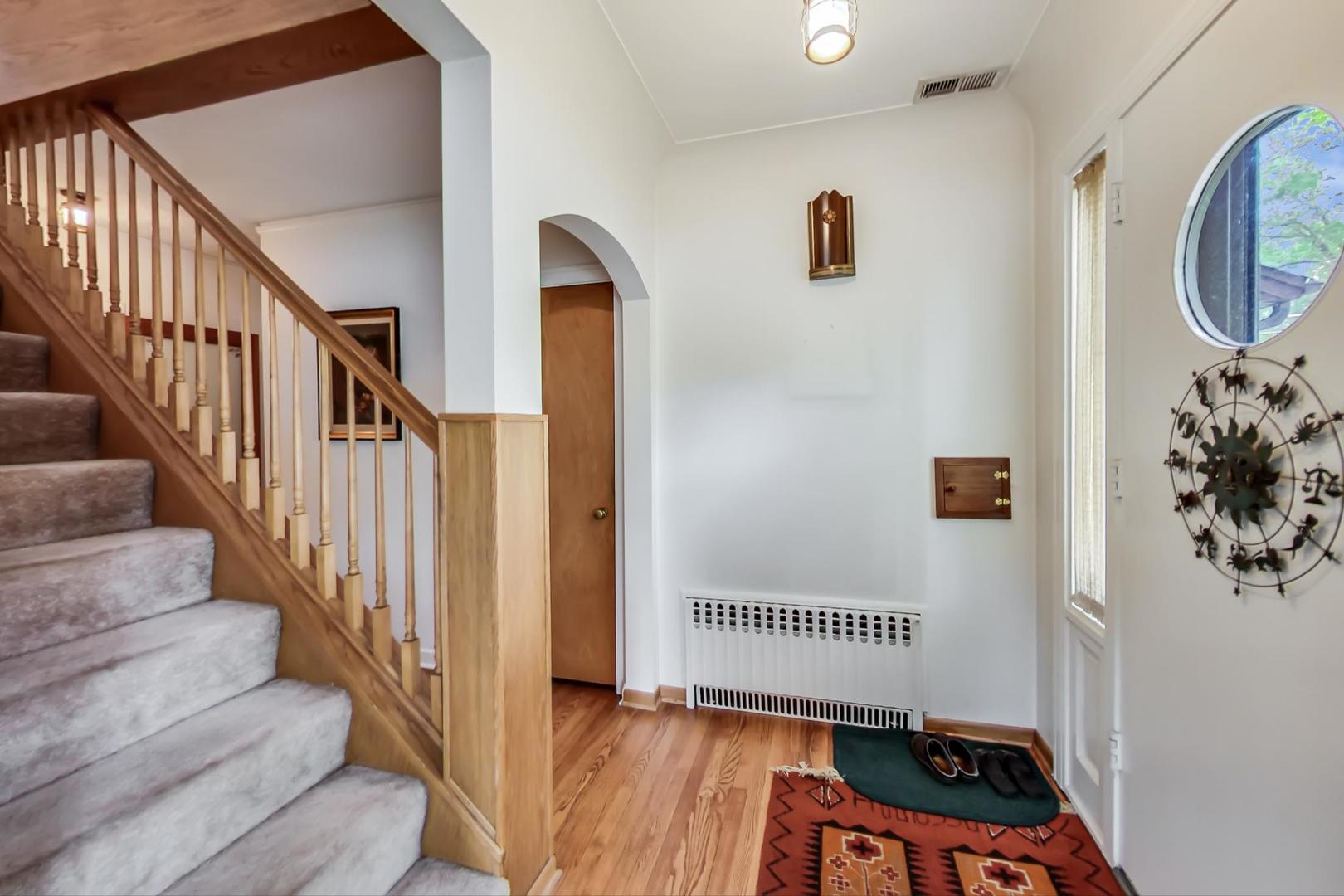 701 South Seminary Avenue Park Ridge, IL 60068 - Photo 7 of 60 a view of a hallway with wooden floor and staircase