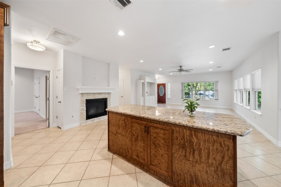 110 Lords Circle Coldspring, TX 77331 - Photo 13 of 34 a hall with kitchen island granite countertop a sink and a stove top oven