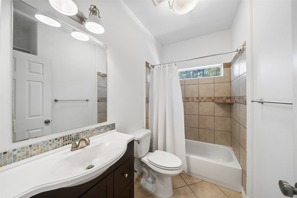 110 Lords Circle Coldspring, TX 77331 - Photo 17 of 34 a bathroom with a sink a toilet and shower