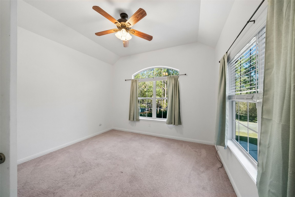 110 Lords Circle Coldspring, TX 77331 - Photo 18 of 34 an empty room with windows and fan