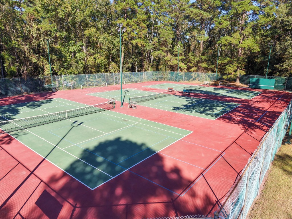 110 Lords Circle Coldspring, TX 77331 - Photo 30 of 34 a view of a tennis ground with large trees