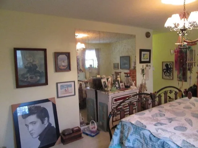 a bedroom with a bed and a flat tv screen