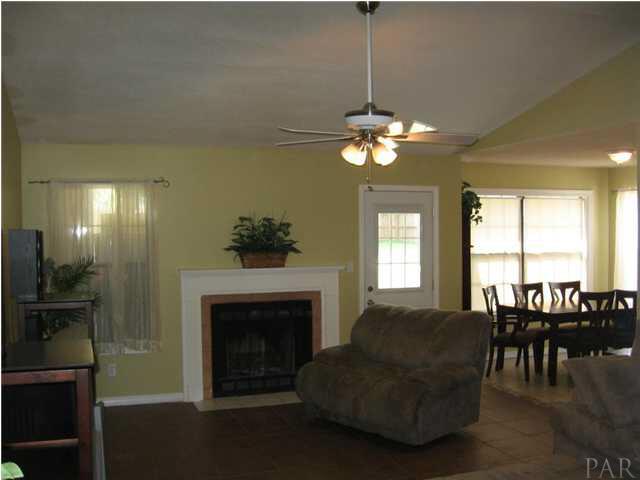 6721 Bellview Pines Road Pensacola, FL 32526 - Photo 3 of 6 View of living room from entry way with fireplace and eat-in kitchen area.